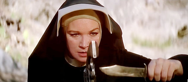 Shirley MacLaine as Sister Sara, praticing the skill she'll need to remove an arrow from Hogan's shoulder in Two Mules for Sister Sara (1970)