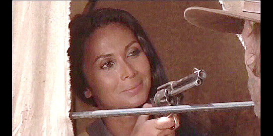 Silvia Monelli as Estella, pulling a gun on a snoop in Acquasanta Joe (1971)