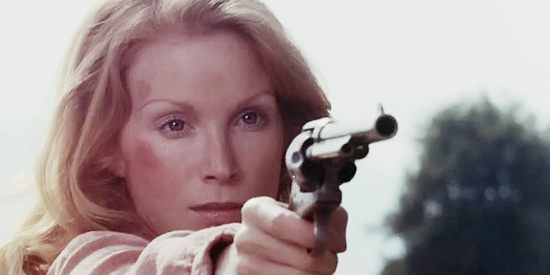 Sondra Currie as Jessi, honing her six-shooting skills for the mission ahead in Jessi's Girls (1975)