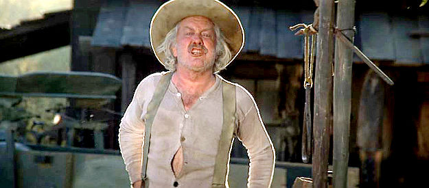 Strother Martin as McCoy, the ferryman who's raft Rooster borrows for a trip downstream in Rooster Cogburn (1975)