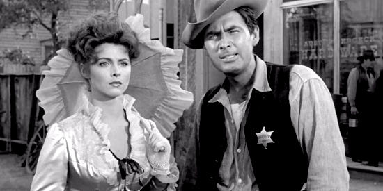 Tina Louise as Selah Jennison and Fess Parker as Sheriff Weston, worried about Bovard's next move in The Hangman (1959)