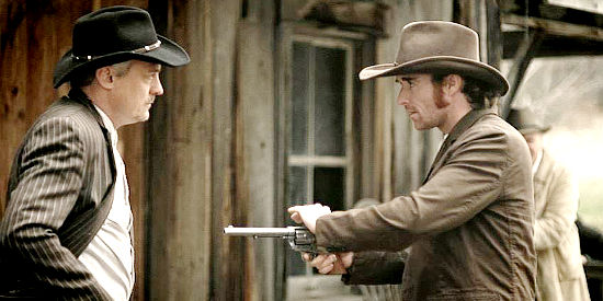 Andrew Galligan as Jesee James, pulling his gun on Emmett Dalton (Peter Whittaker) in Jesse James Lawman (2015)
