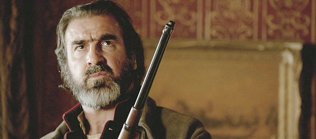 Eric Cantona as Corsican, a Delarue henchman sensing trouble above him in The Salvation (2014)