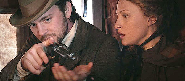 George Blagden as Jake Norman, preparing to defend the stagecoach while wife Sarah (Amber Jean Rowan) looks on in Blood Moon (2015)