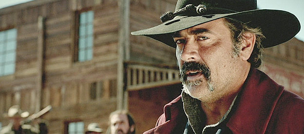 Jeffrey Dean Morgan as Henry Delarue, announcing new demands on the residents of Black Creek in The Salvation (2014)