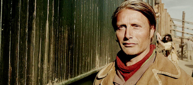 Mads Mikkelsen as Jon Jensen, looking forward to a reunion after seven years of separation from his family in The Salvation (2014)