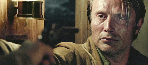 Mads Mikkelsen as Jon Jensen, seeing things going badly on a stage ride home in The Salvation (2014)