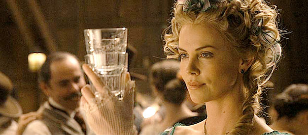 Charlize Theron as Anna, mixing a special concoction for Foy in A Million Ways to Die in the West (2014)