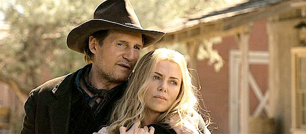 Liam Neeson as Clinch, holding Anna (Charlize Theron) as his bait to lure Albert into a showdown in A Million Ways to Die in the West (2014)
