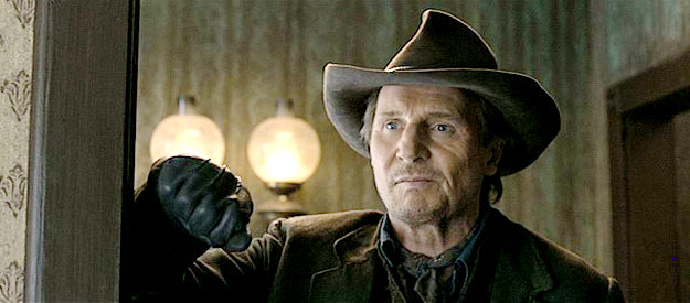 Liam Neeson as Clinch, the gang leader returning for a reunion with his wife Anna in A Million Ways to Die in the West (2014)