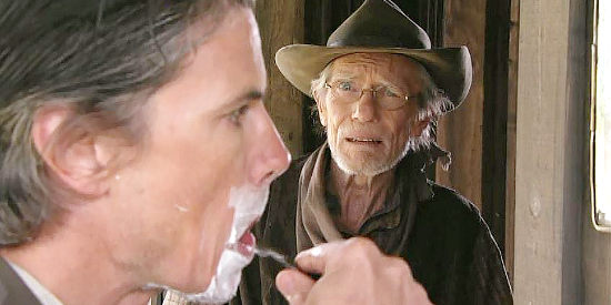 Tom Heaton as Willy, longtime cook and friend of Beau Canfield (Cameron Bancroft), chatting about the arrival of his bride in Mail Order Bride (2008)