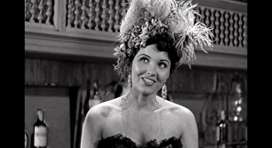 Alyn Lockwood as Rosa, a saloon girl working for Duke Drake and trying to help him get the upper hand over Queenie Hart in Cattle Queen (1951)