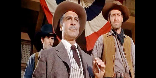 Anthony Caruso as Mayor Turlock, the man who rules Bluerock, with the help of fast gun Pete Martin (Sheb Wooley, right) in The Boy from Oklahoma (1954)