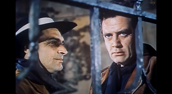 Anthony Caruso as Sgt. Munoz and Raymond Burr as Capt. Rodriguez, determined to capture Juan Obregon for taking the law into his own hands in Passion (1954)