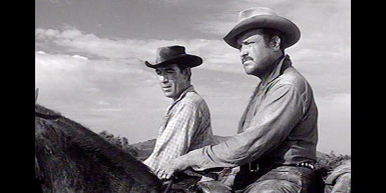 Anthony Quinn as Bob Kallen and William Conrad as Chris Hamish, spotting a band of drunken Apaches in The Ride Back (1957)