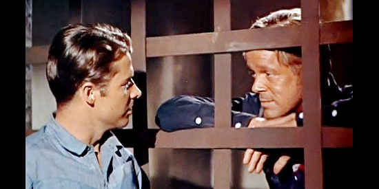 Audie Murphy as Clay O'Mara chats with a jailed Whitney Kincaid (Dan Duryea) in Ride Clear of Diablo (1954)