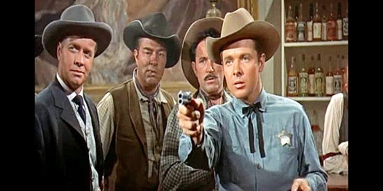 Audie Murphy as Tom Destry, showing he's quite adept at using a gun while Decker (Lyle Bettger) looks on in Destry (1954)