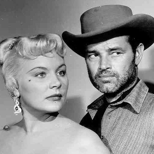 Barbara Payton as Kate and Tom Neal as Arch Clements in The Great Jesse James Raid (1953)