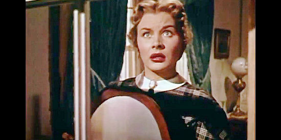Barbara Payton as Kathy Summers, signaling the Confederate troops on Devil Mountain from her bedroom window in Drums in the Deep South (1951)