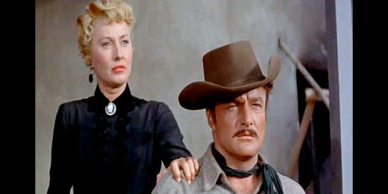 Barbara Stanwyyck as Martha Wilkison and Brian Keith as Cole Wilkison, watching John Parris approach in The Violent Men (1955)