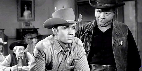 Ben Cooper as Jeff Blaine, ignoring the advice of Marshal Blessingham (Charles Watts) in The Outlaw's Son (1957)