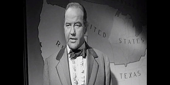 Broderick Crawford as Thomas Craden, standing in front of a map showing a Republic of Texas every bit as big as the United States in Lone Star (1952)