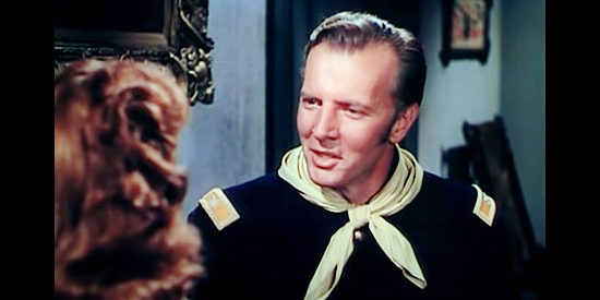 Bruce Bennett as Col. Jeb Britton, meeting the woman his brother was once engaged to in The Last Outpost (1951)