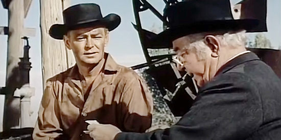 Cecil Kellaway as Dr. Enos Davis, reading a letter about Davy's condition to John Chandler (Alan Ladd) in The Proud Rebel (1958)