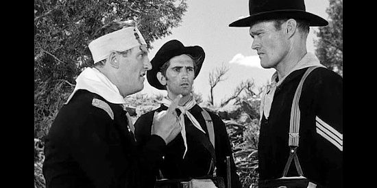 Chuck Connors as Sgt. Wade McCoy, taking command from Lt. Davenport while orderly Miller (Harry Dean Stanton) looks on in Tomahawk Trail (1957)