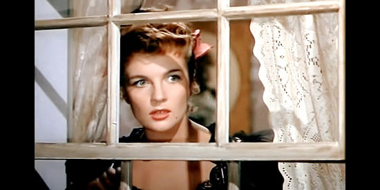 Corinne Calvet as Frenchie Dumont, expecting trouble in the streets in Powder River (1953)
