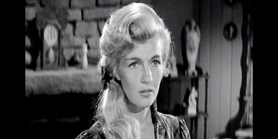 Corinne Calvet as Janet Martin, a former saloon girl trying for a fresh start as a homesteader's wife in Plunderers of Painted Flats (1958)