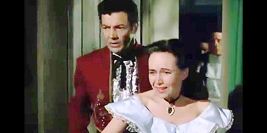 Cornel Wilde as Don Arturo Bordega and Teresa Wright as Julia Lawrence, discovering her father dead in California Conquest (1952)