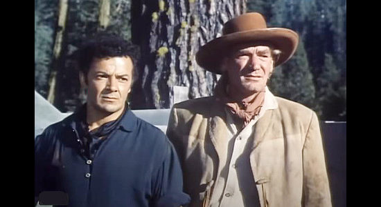 Cornel Wilde as Juan Obregon and John Dierkes as his foreman Escobar, disciplining a ranch hand for harassing Tona in Passion (1954)