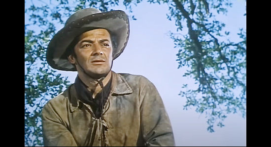 Cornel Wilde as Juan Obregon, returning to the Melo ranch to find he has a new son in Passion (1954)