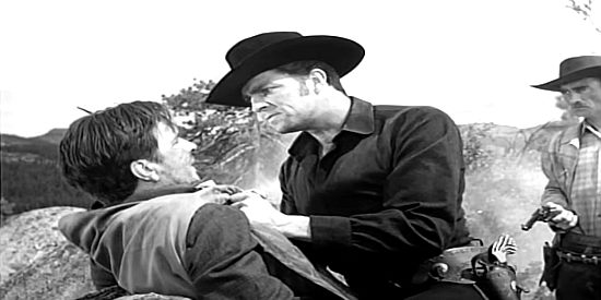 Dale Robertson as Race Crim, trying to beat the truth out of a captured gang member in The Silver Whip (1953)