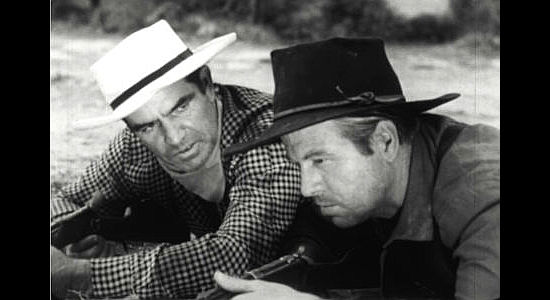 Dan Sheridan as Simmons (left) wondering whether he can trust his father in Seven Guns to Mesa (1958)