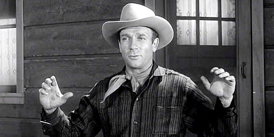 Dane Clark as Nate Blaine, about to be arrested for a killing and bank robbery he didn't commit in The Outlaw's Son (1957)