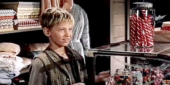 David Ladd as David Chandler, trying to decide which candy is his favorite in The Proud Rebel (1958)