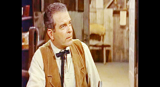 Douglas Kennedy as Hawkins, giving orders to the outlaw gang for its next job in Last of the Badmen (1957)