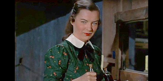 Ella Raines as Celia Evarts, caring for the wounded Ike Adams in Ride the Man Down (1952)