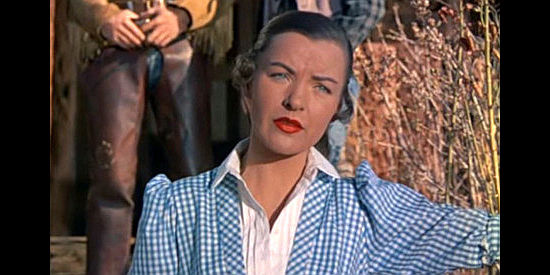 Ella Raines as Celia Evarts, ordering Bide Marriner off the Hatchet ranch her father built in Ride the Man Down (1952)