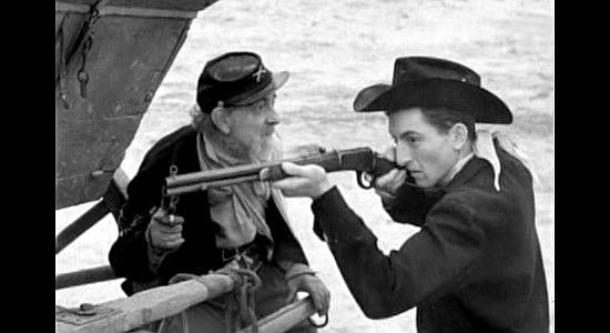 Emmett Lynn as Old Grimer and Robert 'Buzz' Henry as Charlie, protecting the wagons during an Indian attack in The Homesteaders (1953)