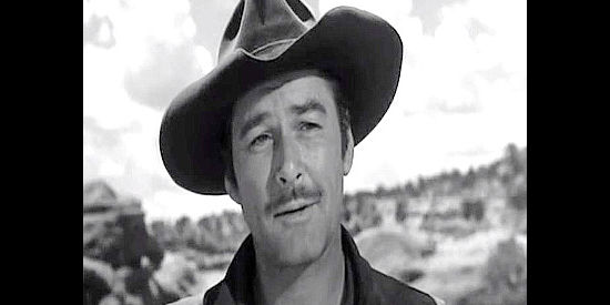 Errol Flynn as Capt. Lafe Barstow, pondering post-war possibilities with Johanna Carter in Rocky Mountain (1950)