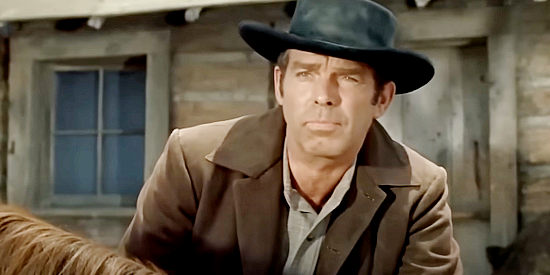 Fred MacMurray as Neal Harris, the newspaperman sent West to investigate in The Oregon Trail (1959)