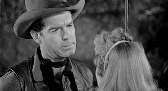 Fred MacMurray as Wes Anderson, trying to reason with Rela in The Moonlighter (1953)