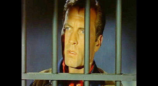 George Montgomery as Dan Barton, waiting for an outlaw gang to break him out of jail in Last of the Badmen (1957)