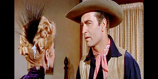 George Montgomery as Dan Beattie getting a warning from the suddenly helpful Nancy in The Man from God's Country (1958)