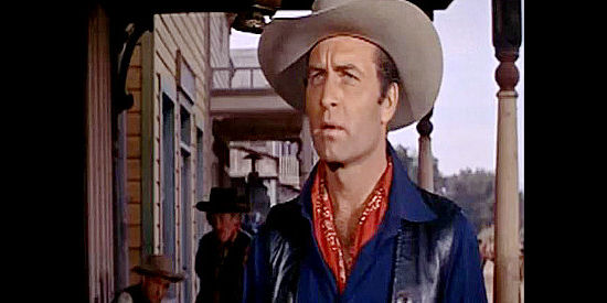 George Montgomery as Steve Patrick, hatching a plan to save the Wyoming cattle industry in Canyon River (1956)