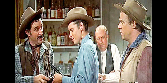 George Wallace as Curly, getting his six-gun checked by Destry (Audie Murphy) while Mac (Richard Reeves) looks on in Destry (1954)