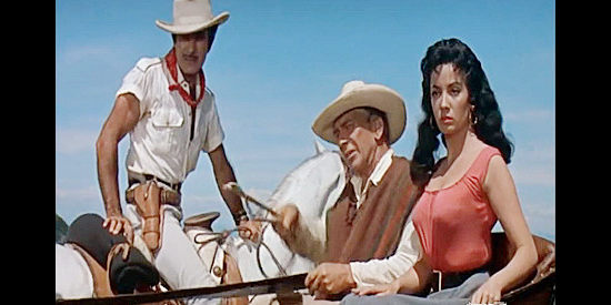 Gilbert Roland as Miles Garrett and Eduard Franz as Father Jose debate the best route to safety while Maria (Linda Cristal) listens in The Last of the Fast Guns (1958)